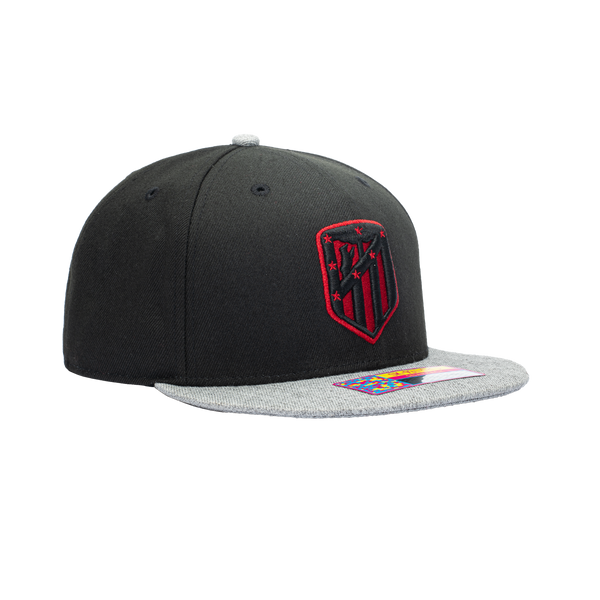 Left side view of a snapback atletico madrid with black and red team logo on the front.