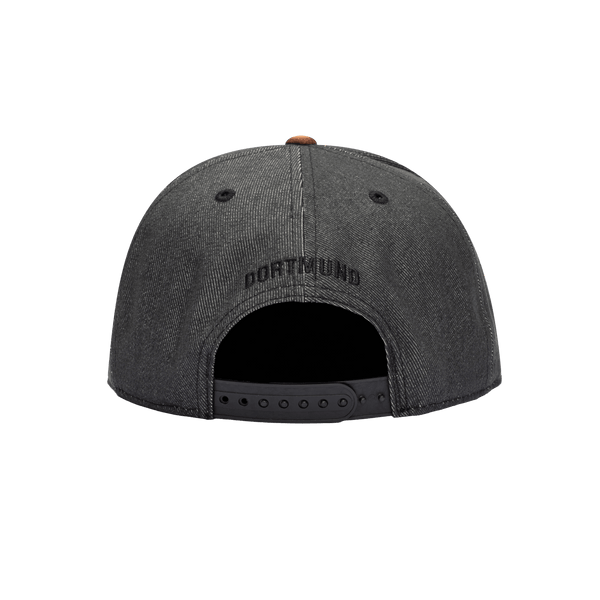 Back view of the Borussia Dortmund Orion Snapback with high structured crown, flat peak suede-like brim, and snapback closure, in Black/Brown.