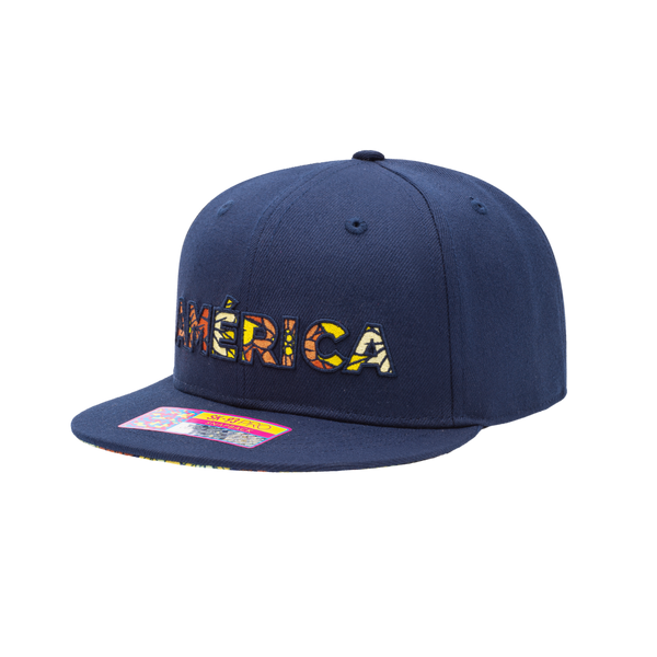 Club America Day of the Dead Snapback Hat with America script with marigold floral overlay embroidered on the front, Club America logo embroidered on the side, "Dia de Muertos" embroidered on the back, and marigold floral print on the under peak. The hat has a high crown, flat peak brim, and a snapback closure.